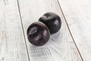 Two ripe sweet black plums