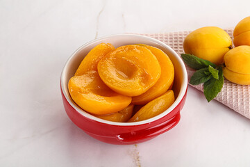 Few canned aprocots in the bowl