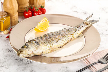 Grilled sea bass fish served lemon