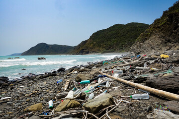 marine garbage debris driftwood Styrofoam Polystyrene foam. Plastic box on deserted shore magnificent coastline stretches behind, Environmental pollution issues © leo tsao