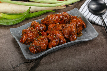 Manchurian chicken with sauce and spices