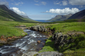 A river flowing through the scenic and picturesque landscape of Seydisfjordur fjord  town in Iceland