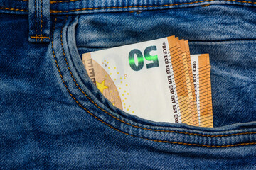 Concept of financial problems, last money. 50 euro banknote in jeans pocket.