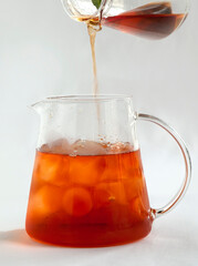 Iced tea with Ice cubes in glass pitcher