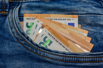 Euro bills in jeans pocket background. Euro banknotes in jeans back pocket.