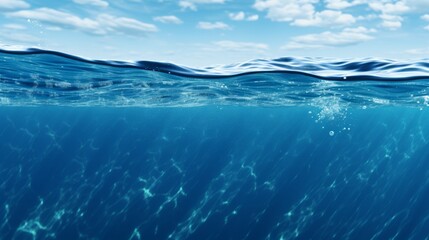Blue sea or ocean water surface and underwater with sunny and cloudy sky
