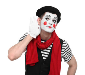 Mime artist showing hand to ear gesture on white background