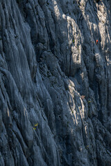 Silhouette of a climber on a steep rock. Mount Anica Kuk, Paklenica National Park, Croatia.