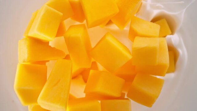 Super Slow Motion Shot of Mango Cuts Followed by Camera Falling into Yogurt at 1000fps.