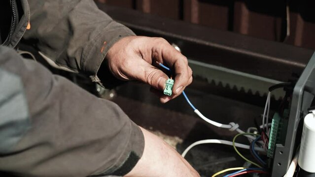 Electrician installs wiring using Connectors for connecting wires in automation and electronics equipment. Connection of electrical wires of electrical appliances