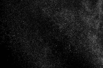 Black and white grunge texture background. Abstract splashes of water on dark backdrop. Light clouds overlay.	