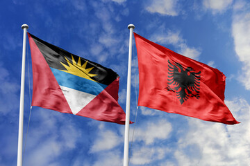  3d illustration. Antigua and Barbuda and Albania Flag waving in sky. High detailed waving flag. 3D render. Waving in sky. Flags fluttered in the cloudy sky.
