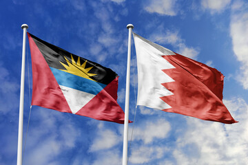 Naklejka premium 3d illustration. Antigua and Barbuda and Bahrain Flag waving in sky. High detailed waving flag. 3D render. Waving in sky. Flags fluttered in the cloudy sky.