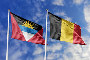  3d illustration. Antigua and Barbuda and Belgium Flag waving in sky. High detailed waving flag. 3D render. Waving in sky. Flags fluttered in the cloudy sky.