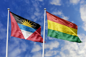  3d illustration. Antigua and Barbuda and Bolivia Flag waving in sky. High detailed waving flag. 3D render. Waving in sky. Flags fluttered in the cloudy sky.