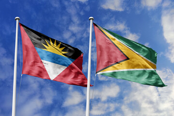  3d illustration. Antigua and Barbuda and Guyana Flag waving in sky. High detailed waving flag. 3D render. Waving in sky. Flags fluttered in the cloudy sky.