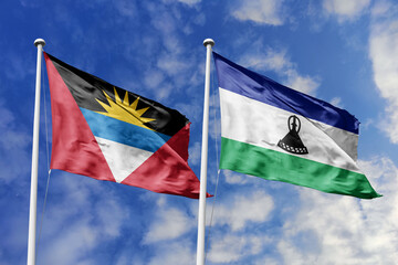 3d illustration. Antigua and Barbuda and Lesotho Flag waving in sky. High detailed waving flag. 3D...