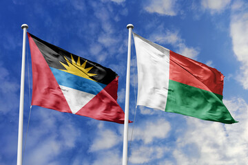 3d illustration. Antigua and Barbuda and Madagascar Flag waving in sky. High detailed waving flag....