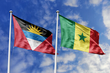 3d illustration. Antigua and Barbuda and Senegal Flag waving in sky. High detailed waving flag. 3D render. Waving in sky. Flags fluttered in the cloudy sky.