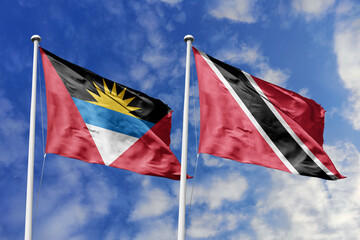 3d illustration. Antigua and Barbuda and Trinidad and Tobago Flag waving in sky. High detailed waving flag. 3D render. Waving in sky. Flags fluttered in the cloudy sky.