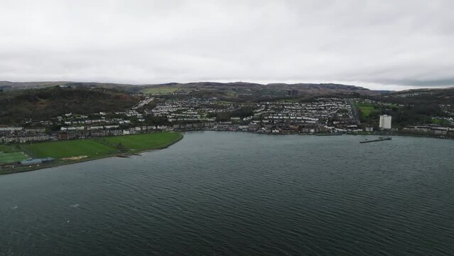 Greenock, Scotland on a windy day over the River Clyde slow push in as we look back at the town