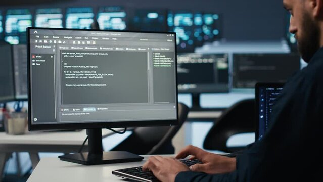 IT employee programming in server hub housing supercomputers storing datasets. Close up shot of expert typing code on computer to mend data center racks doing complex computational operations