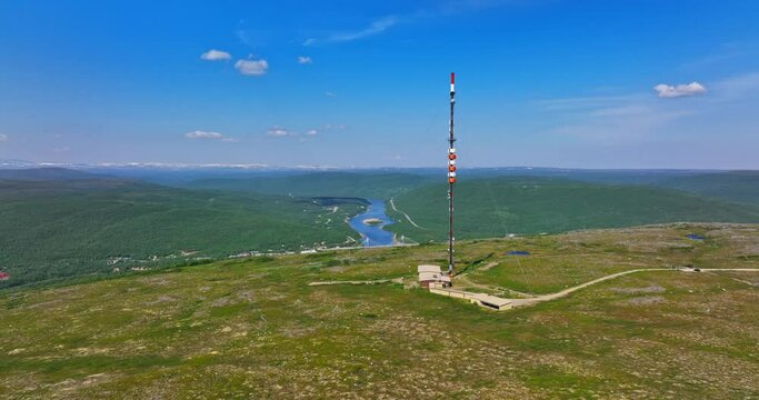 Aerial ascending shot a radio tower on top of a fell in Utsjoki, Finland