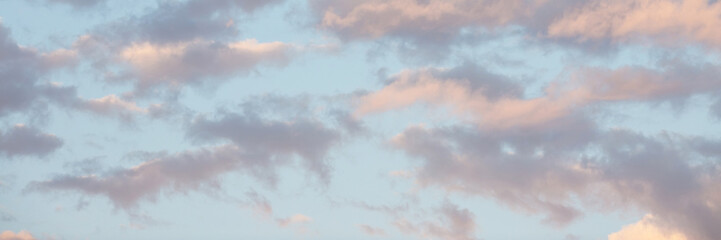 Beautiful sunset sky background with clouds. Scenic cloudscape. Wide panoramic background for...