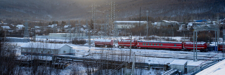 View of the railway and fire train. Winter industrial landscape. Baikal-Amur Mainline (BAM), Far...