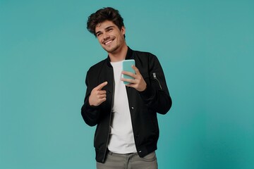 Cheerful sporty red-haired guy shows a finger on the smartphone screen on a blue background.