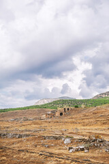 Ancient historical ruins in Pamukkale Turkey on the dramatic sky background