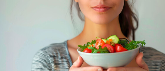 Close up woman holding a bowl of salad, promoting mental health and general well-being