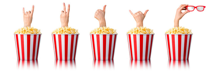 Female hand sticks out of a bucket with popcorn isolated on white background