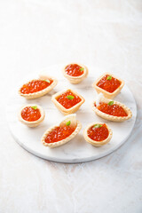 Red caviar served in tartlets
