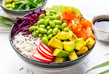 Poke bowl for balanced nutrition with salmon, avocado, radish, cabbage, edamame beans and rice,...
