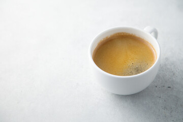 Black coffee served in a white cup