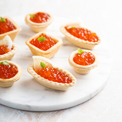 Red caviar served in tartlets