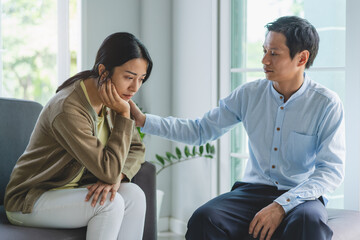 mental health treatment concept. Stressed asian patient talking with personal psychologist in...