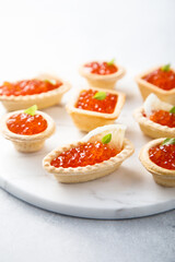 Red caviar served in tartlets