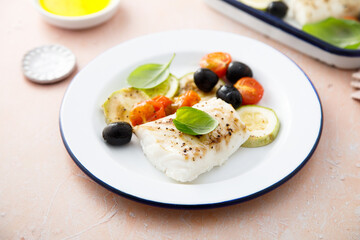 Roasted cod with olives, tomato and zucchini