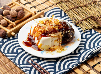 Preserved egg tofu with chopsticks served in plate isolated on napkin side view on table taiwan food