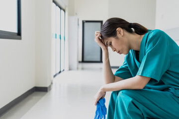 Asian female nurse feeling depress with hospital work