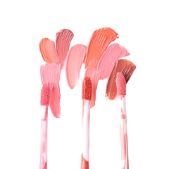 Strokes of different lip glosses and applicators isolated on white, top view