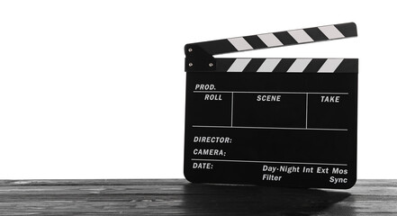Movie clapper on wooden table against white background, space for text