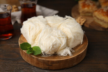 Eastern sweets. Tasty Iranian pashmak on wooden table, closeup