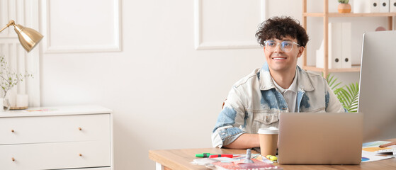 Male graphic designer working at table in office