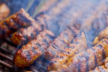 (mici) on the grill while it is cooking.