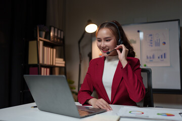 Female entrepreneur serving customers Business information, inquiries, Asian call center with headset and microphone working on laptop Customer Service Center Representative Support Help customers.