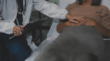 Cropped shot of a female nurse hold her senior patient's hand. Giving Support. Doctor helping old...