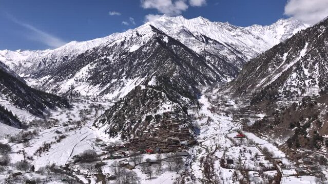 Scenic Kalasha Village in Bamburet Valley in North Pakistan at Winter. Aerial View Hindu Kush Muntain Range Himalayas.